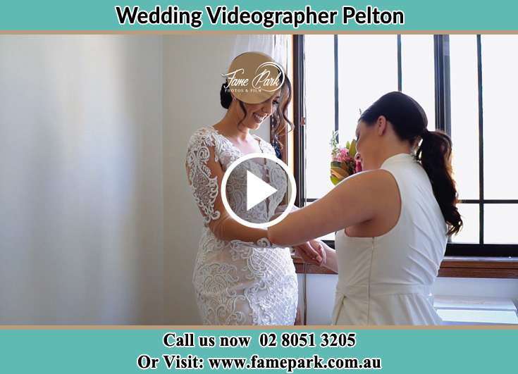 A woman helping the Bride to get ready for the wedding Pelton NSW 2325